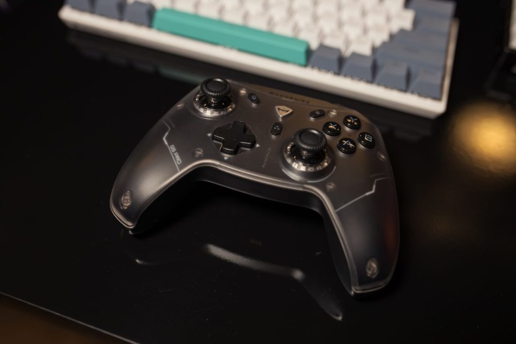 A game controller beside a keyboard on a gaming desk